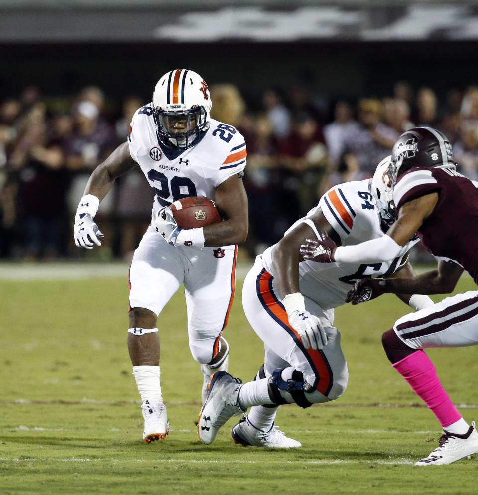 Auburn running back JaTarvious Whitlow (28) picks up yards against Mississippi State during the first half of their NCAA college football game in Starkville, Miss., Saturday, Oct. 6 2018. (AP Photo/Rogelio V. Solis)