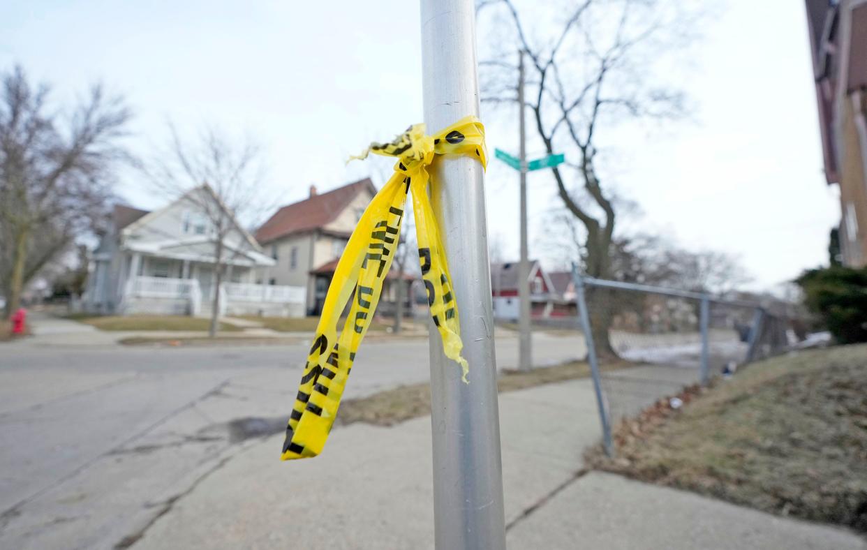 Police tape remains at the scene near where a 15-year-old boy was shot and killed while five others were injured in the 1400 block of W. Concordia Ave. in Milwaukee on Monday night.