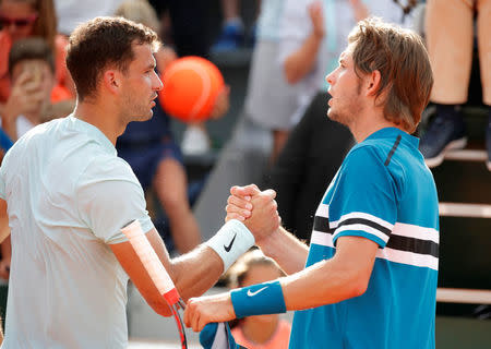 Tennis - French Open - Roland Garros, Paris, France - May 30, 2018 Bulgaria's Grigor Dimitrov shakes hands with Jared Donaldson of the U.S. after winning their second round match REUTERS/Charles Platiau