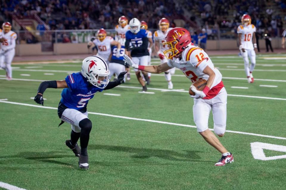 Jesuit Marauders wide receiver Maximus Diepenbrock (12) runs the ball for 13 yards before being tackled by Christian Brothers Falcons defensive back Zachary Castillo (5) in the Holy Bowl on Saturday at Hughes Stadium.