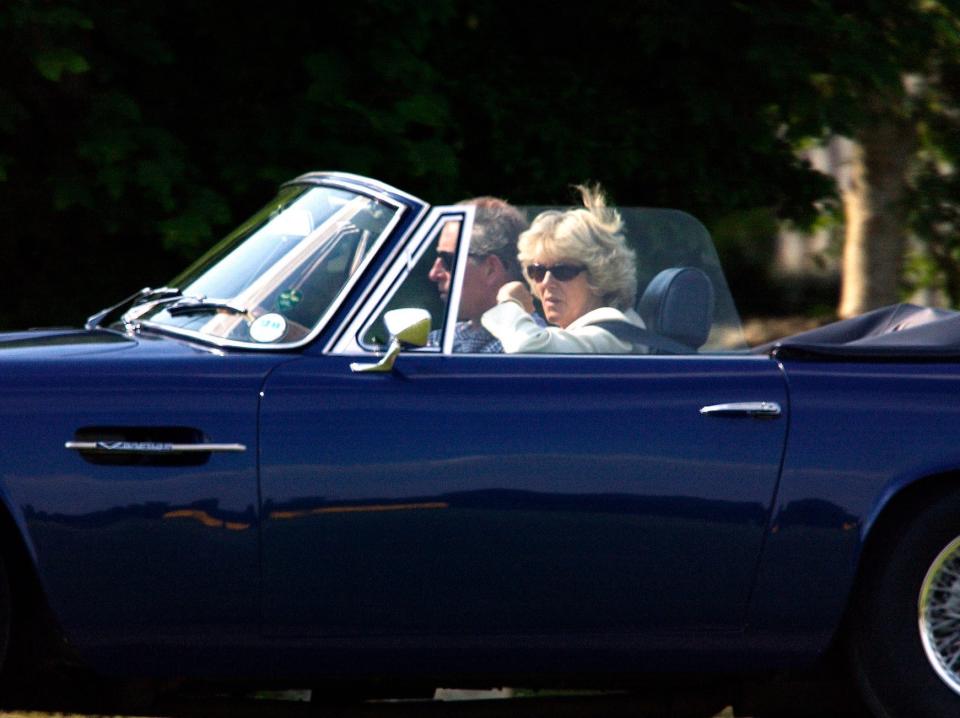 King Charles III and Camilla Parker Bowles drive a convertible in 2003.