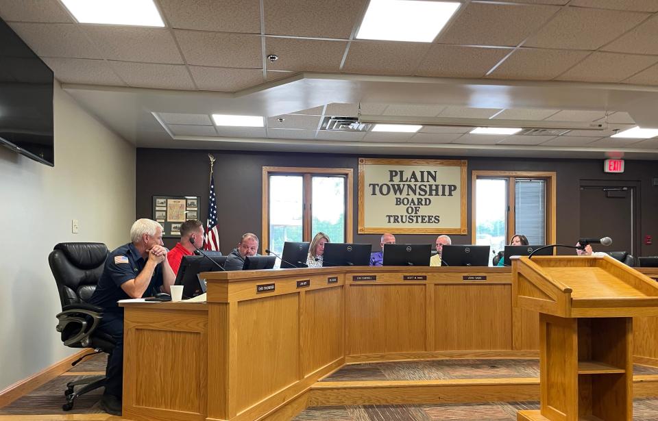 Plain Township Highway Superintendent J.P. Neff, left in the red shirt, presents road levy increase options to the township trustees Tuesday at Plain Township Hall. He said due to rising costs his department can only pave 10 miles of road for $1.86 million versus 17 miles of road in 2018 on $1.44 million.