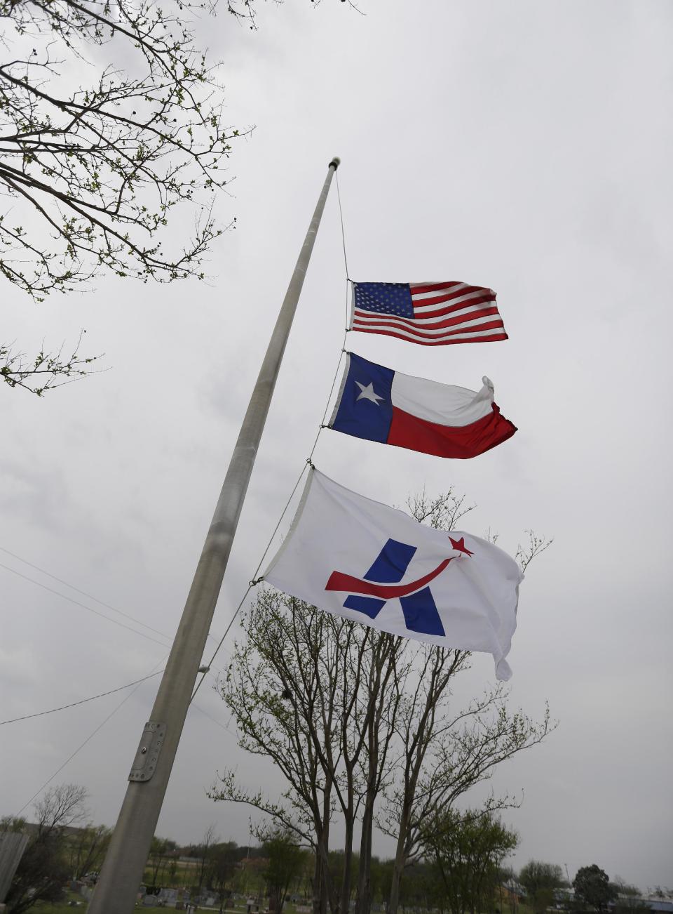 The U.S., Texas and City of Killeen flags fly at at half staff for shooting victims, Thursday, April 3, 2014, in Killeen, Texas. A soldier, Spc. Ivan Lopez, opened fire Wednesday on fellow service members at the Fort Hood military base, killing three people and wounding 16 before committing suicide. (AP Photo/Eric Gay)