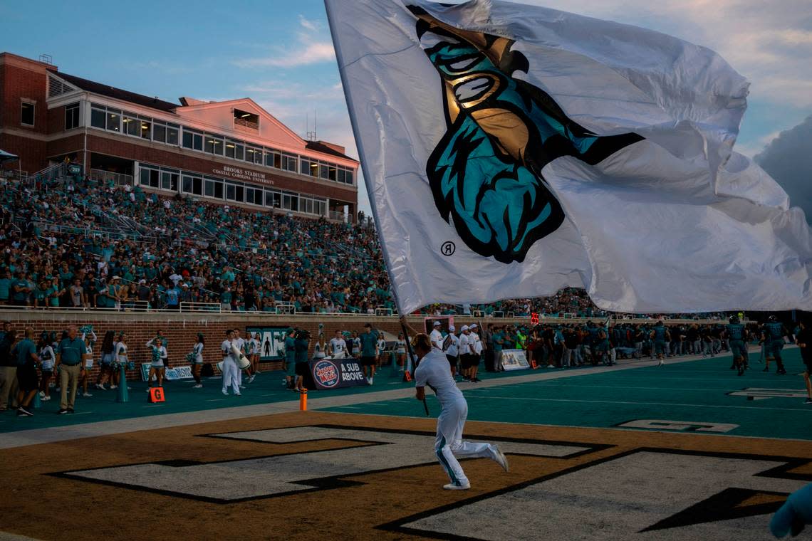 Coastal flags fly as the Chanticleers score their first touchdown against Army. Coastal Carolina University beat Army in the first game of the 2022 season at Brooks Stadium 38-28. A record crowd of 21,165 attended the game. Sept. 3, 2022.