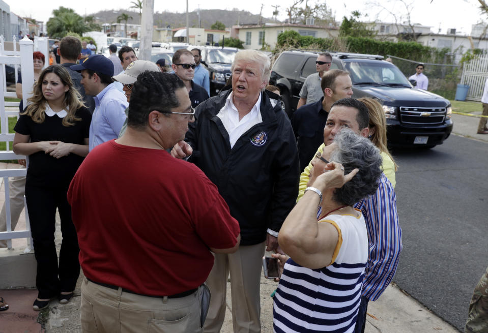 <p>President Donald Trump talks to residents while taking a walking tour to survey hurricane damage and recovery efforts in a neighborhood in Guaynabo, Puerto Rico, Tuesday, Oct. 3, 2017. (Photo: Evan Vucci/AP) </p>