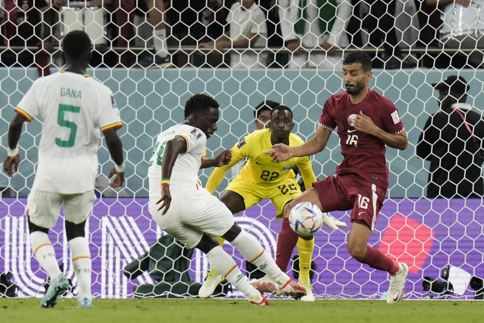Senegal's Bamba Dieng scores a goal during the World Cup group A soccer match between Qatar and Senegal, at the Al Thumama Stadium in Doha, Qatar, Friday, Nov. 25, 2022. (AP Photo/Hassan Ammar)