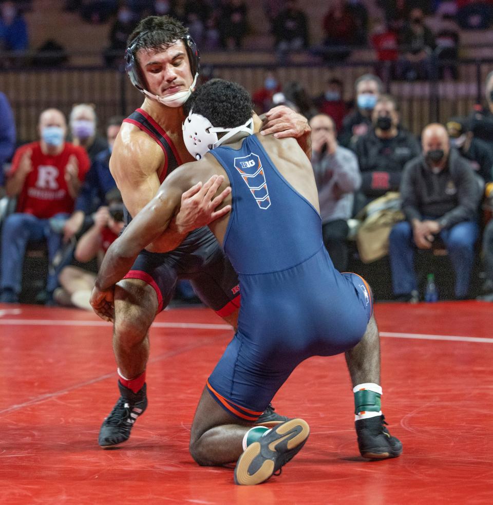 Rutgers University's Sebastian Rivera takes Illinois' We Rachal down to the mat in his win by technical fall Friday night in the Scarlet Knights' 21-13 win over the Illini. The win was the 100th of Rivera's career.