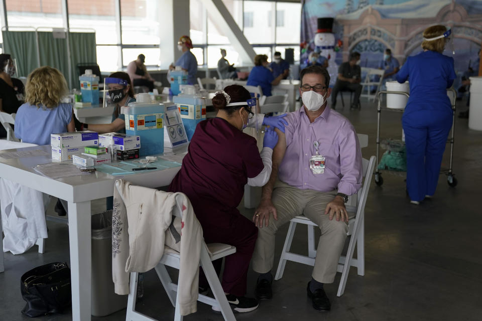 Dr. Michael Forino, right, gets the Pfizer-BioNTech COVID-19 vaccine at St. Joseph Hospital in Orange, Calif., Thursday, Jan. 7, 2021. (AP Photo/Jae C. Hong)