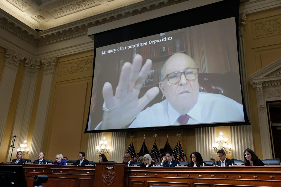 Rudy Giuliani appears on a video screen during videotaped testimony above members of the Select Committee to Investigate the January 6th Attack on the U.S. Capitol during the seventh hearing on the January 6th investigation in the Cannon House Office Building on July 12, 2022 in Washington, DC.