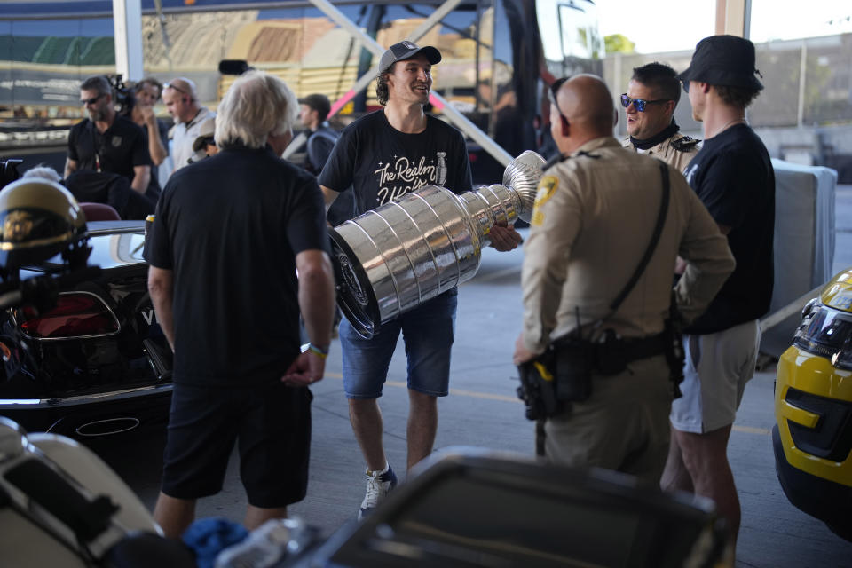 Vegas Golden Knights right wing Mark Stone (61) holds the Stanley Cup before a parade along the Las Vegas Strip for the NHL hockey champions Saturday, June 17, 2023, in Las Vegas. (AP Photo/John Locher)