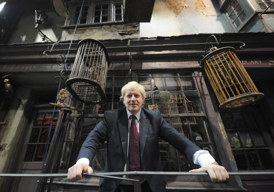 Mayor of London Boris Johnson poses in Diagon Alley as he visits the new attraction 'The Making of Harry Potter' at Warner Brothers studios in Leavesden, Hertfordshire. PRESS ASSOCIATION Photo Monday December 19, 2011. Photo credit should read: Anthony Devlin/PA