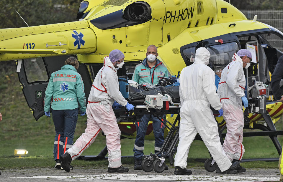 A COVID-19 patient from the Netherlands arrives for treatment by helicopter to the University hospital in Muenster, Germany, Friday, Oct. 23, 2020. The transfer is intended to reduce the coronavirus pressure on the intensive care units in the Netherlands. (AP Photo/Martin Meissner)