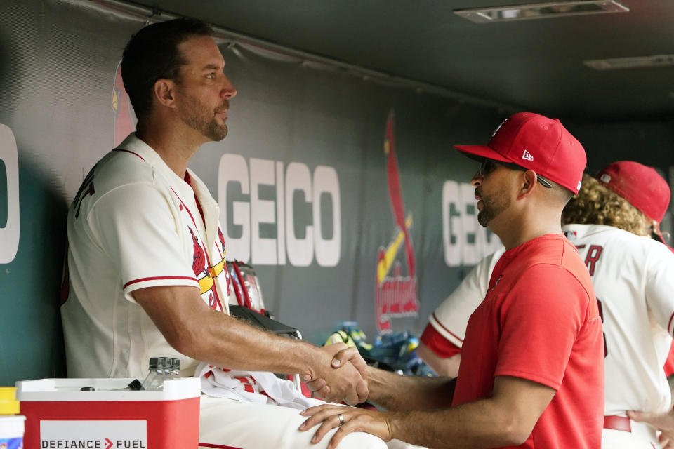 St. Louis Cardinals starting pitcher Adam Wainwright, left, gets a handshake from Cardinals manager Oliver Marmol after working the seventh inning of a baseball game against the Cincinnati Reds Saturday, June 11, 2022, in St. Louis. (AP Photo/Jeff Roberson)