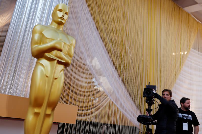 A camera crew runs through a shot movement around an Oscar statue in preparation for the 92nd Academy Awards in Los Angeles