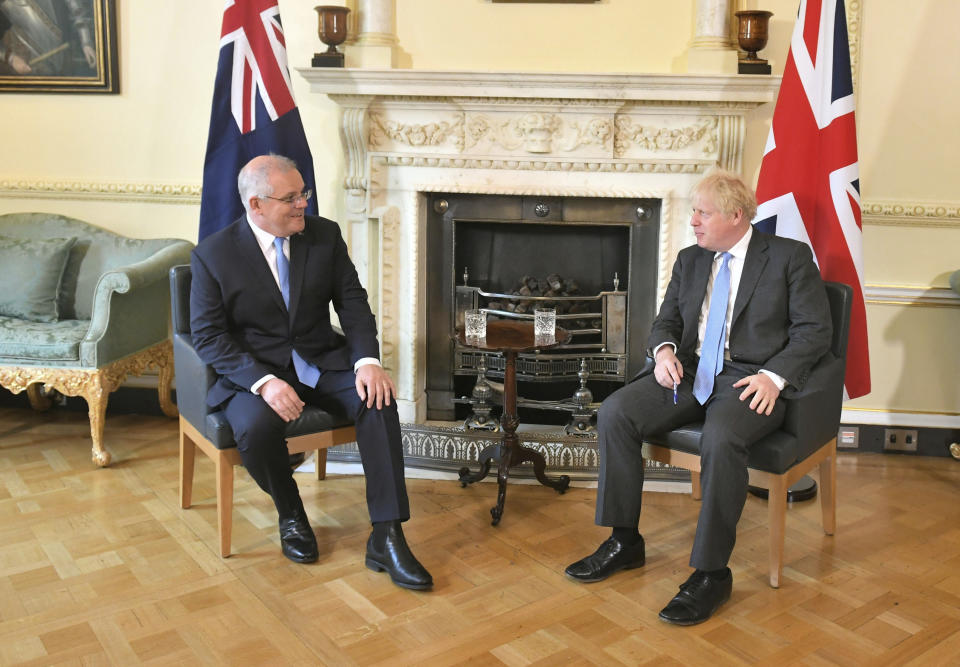 Britain's Prime Minister Boris Johnson, right, poses for a photo with Australian Prime Minister Scott Morrison, ahead of their meeting, at 10 Downing Streeet, in London, Tuesday June 15, 2021. Britain and Australia have agreed on a free trade deal that will be released later Tuesday, Australian Trade Minister Dan Tehan said. (Dominic Lipinski/Pool Photo via AP)