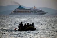 Migrants arrive on the Greek island of Kos island on a small dinghy on August 19, 2015