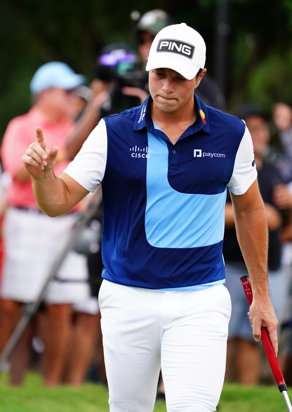 Viktor Hovland waves to the gallery after his putt on the first green during the final round of the TOUR Championship golf tournament at East Lake Golf Club.