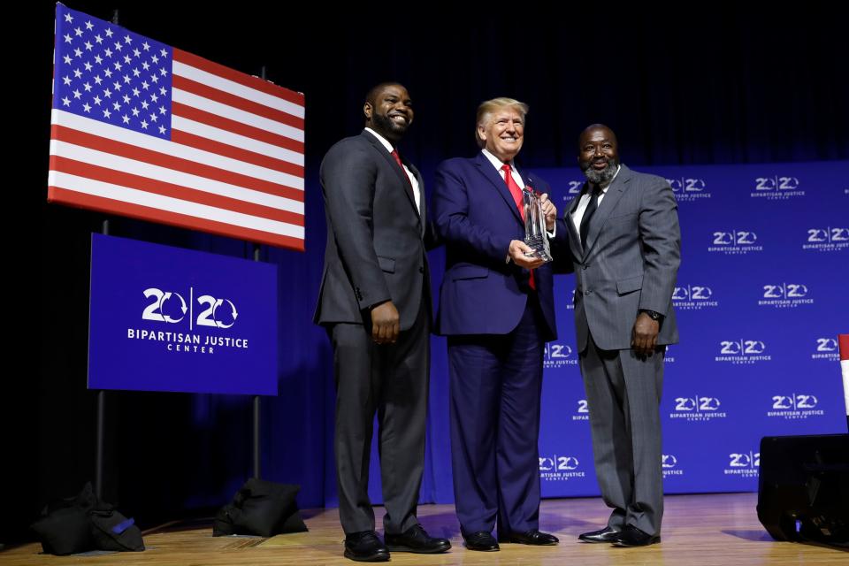 President Donald Trump is awarded the Bipartisan Justice Award by Matthew Charles, right, one of the first prisoners released by the First Step Act, during the "2019 Second Step Presidential Justice Forum" at Benedict College on Oct. 25 in Columbia, S.C.