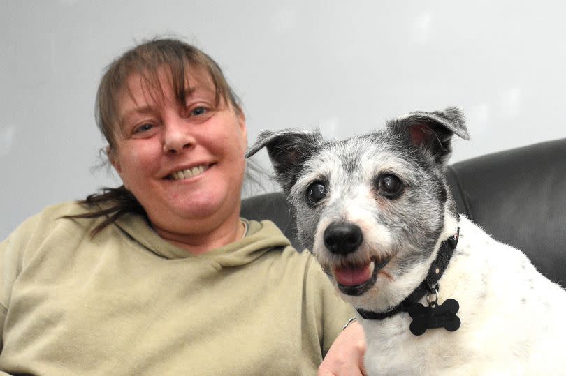 Lucy with owner Janine Webb at home on the sofa