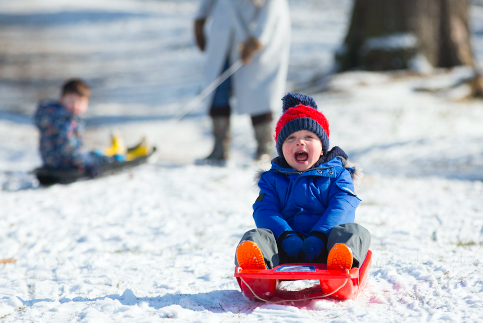 <em>Three-year-old Wilfred Martin, enjoys sledding in the snow in Richmond Park, London (PA)</em>