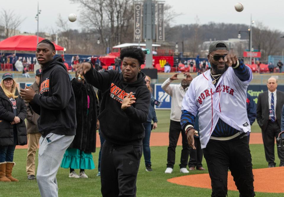 North High basketball players Joe Okla, left, and Amaren Minor, center. join Boston Red Sox legend David Ortiz to throw out the first pitch of the 2023 Worcester Red Sox season at Polar Park.