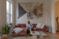 <p>Chris Echevarria lounges on a pink couch in his collaboration with Sperry.</p>
