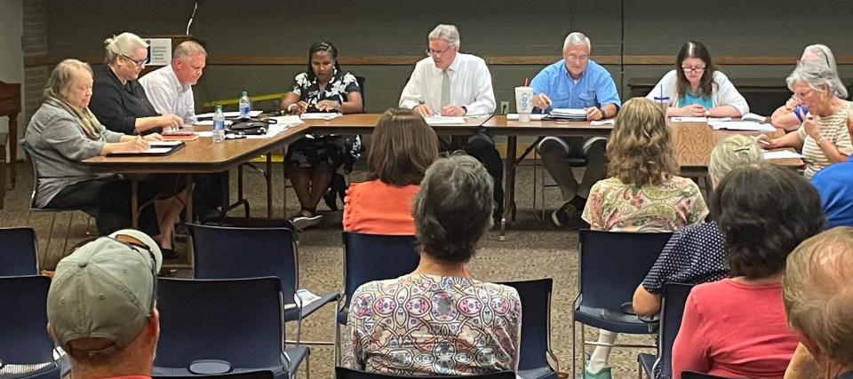 Library Board members assembled to discuss community issues concerning a LGBTQ display at the library.