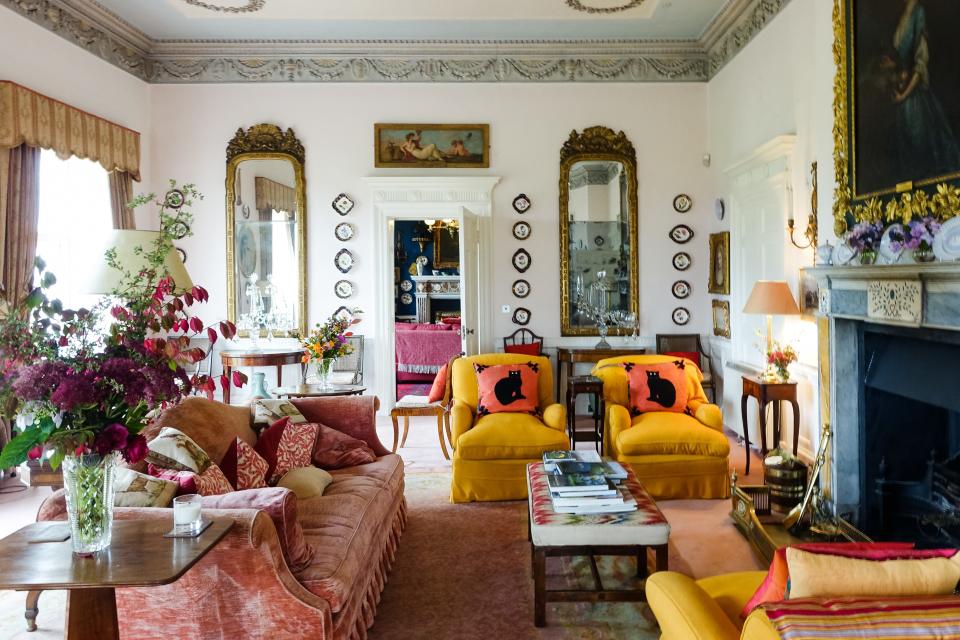 The drawing room is light-filled with brightly colored accents and an embellished mantel at the center of the room, adding a stateliness. The house's original features are still intact, from the decorative ceilings to the mahogany doors; Fitzgerald’s favorite objects in the house are the ornate mantelpieces and fireplaces.