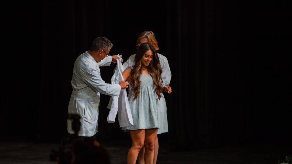Bailee Alonzo of Lubbock receives her white coat during Friday's by the Texas Tech University Health Sciences Center ceremony at the Buddy Holly Hall of Performing Arts and Sciences.