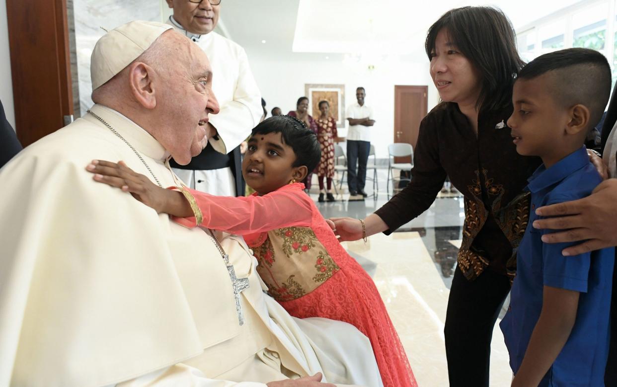 Pope Francis greets children at the Apostolic Nunciature in Indonesia