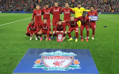 Liverpool players pose for a team group photo before the match - Credit: Reuters