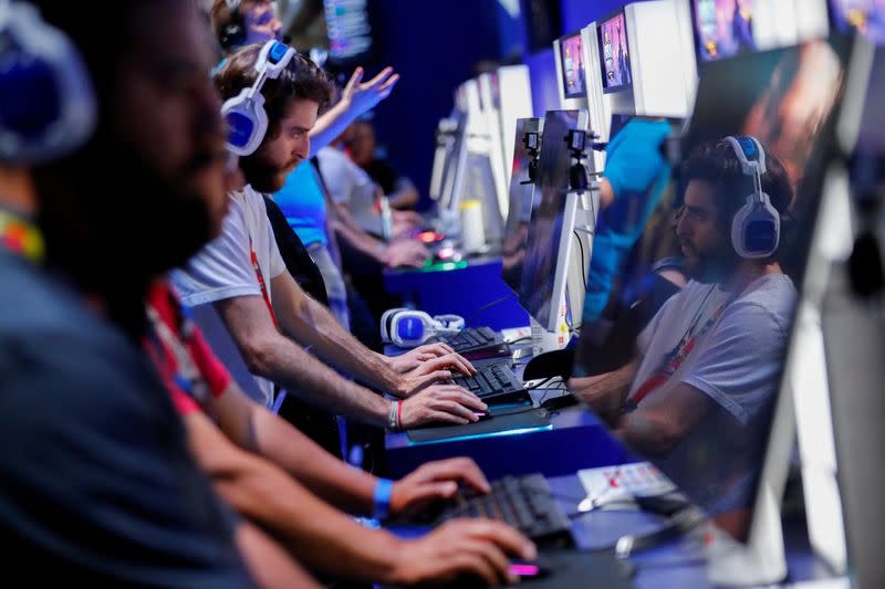 FILE PHOTO: Attendees play video games at E3, the world's largest video game industry convention in Los Angeles