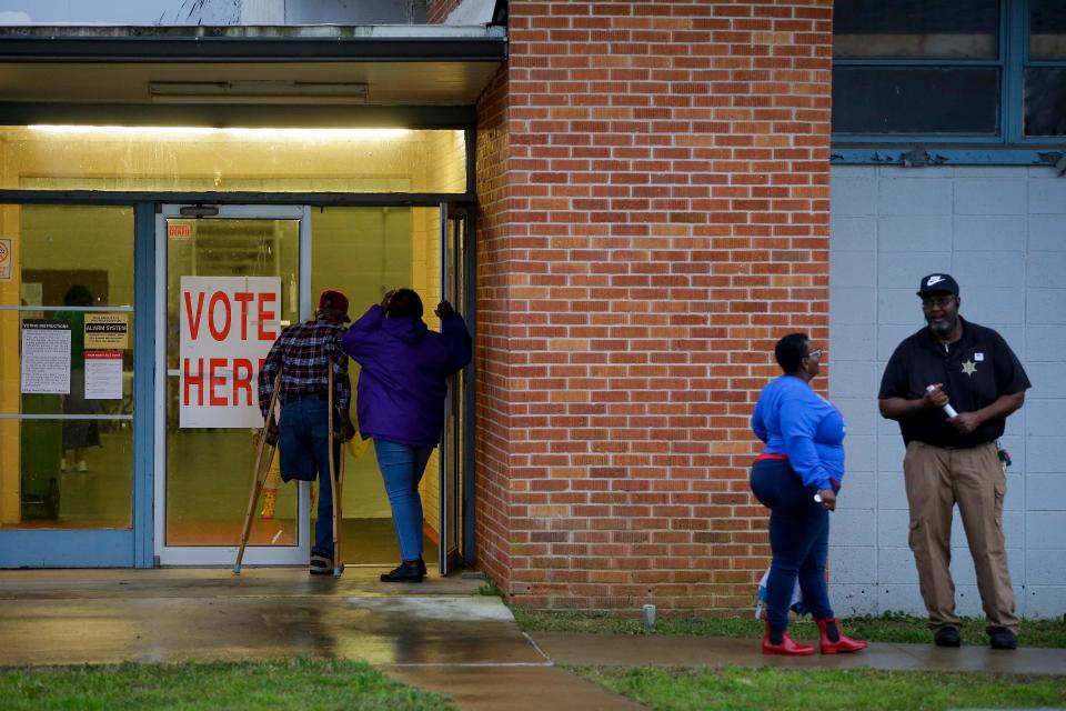 Voters enter a polling station at the National Guard Military Base during the presidential primary in Camden, Alabama on Super Tuesday, March 3, 2020. - Fourteen states and American Samoa are holding presidential primary elections, with over 1400 delegates at stake. Americans vote Tuesday in primaries that play a major role in who will challenge Donald Trump for the presidency, a day after key endorsements dramatically boosted Joe Biden's hopes against surging leftist Bernie Sanders. The backing of Biden by three of his ex-rivals marked an unprecedented turn in a fractured, often bitter campaign. (Photo by Joshua Lott / AFP) (Photo by JOSHUA LOTT/AFP via Getty Images)