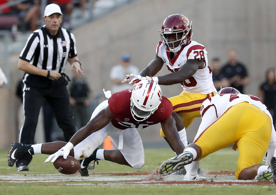 Stanford linebacker Bobby Okereke (20) recovers a fumble in front of Southern California running back Aca'Cedric Ware (28) during the first half of an NCAA college football game, Saturday, Sept. 8, 2018, in Stanford, Calif. (AP Photo/Tony Avelar)