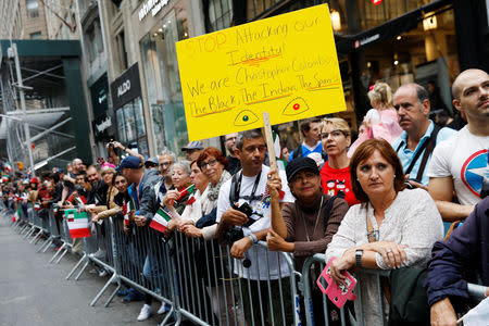 A woman holds a sign during the 74th Annual Columbus Day Parade in Manhattan, New York, U.S., October 8, 2018. REUTERS/Shannon Stapleton