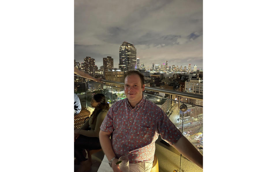 This photo provided by Linda Clary shows her son John Umberger at a rooftop bar in New York, on May 27, 2022. Multiple people, including Umberger, have been fatally poisoned with narcotics in what investigators say were schemes by criminal crews to incapacitate and rob people at New York City bars and nightclubs. (Doug Davenport/Courtesy of Linda Clary via AP)