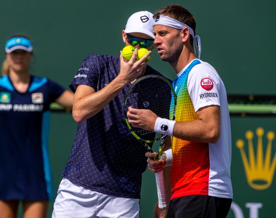 Jamie Murray leans in to come up with a plan with partner Michael Venus during round one of doubles play at the BNP Paribas Open in Indian Wells, Calif., Sunday, March 10, 2024.