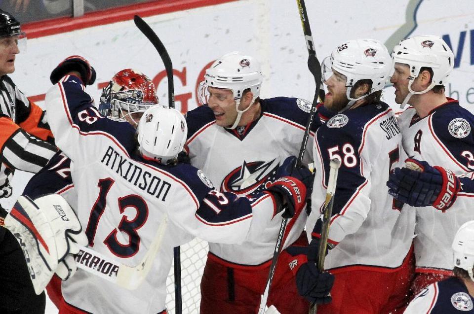 Columbus Blue Jackets goalie Sergei Bobrovsky (72) is congratulated by teammates Cam Atkinson (13), Jack Johnson (7), David Savard (58) and Boone Jenner (38) after the Blue Jackets defeated the Minnesota Wild 4-2 during an NHL hockey game Saturday, Dec. 31, 2016, in St. Paul, Minn. (AP Photo/Andy Clayton-King)