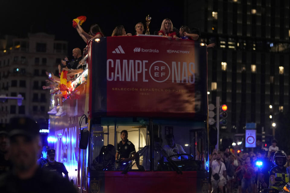 Spain's Women's World Cup soccer team celebrate on top of bus as they arrive in Madrid, Spain, Monday, Aug. 21, 2023. Spain beat England in Sydney Sunday to win the Women's World Cup soccer final. (AP Photo/Manu Fernandez)