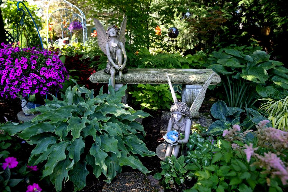Angels add a lively touch to Dorothy Danforth's garden.