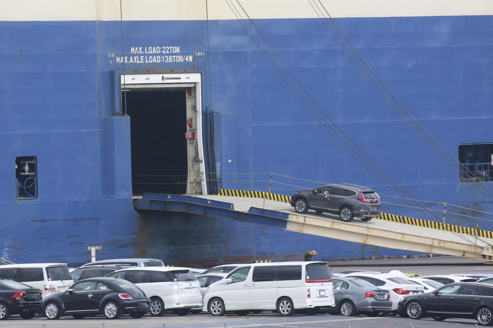 FILE - Cars for export are loaded onto a cargo ship at a port in Yokohama, near Tokyo on Nov. 2, 2021. The Japanese economy shrank at an annual rate of 1.8% in the first quarter of this year, according to government data Monday, June 10, 2024, revised to be slightly better than the initial estimate at a 2.0% contraction. (AP Photo/Koji Sasahara, File)