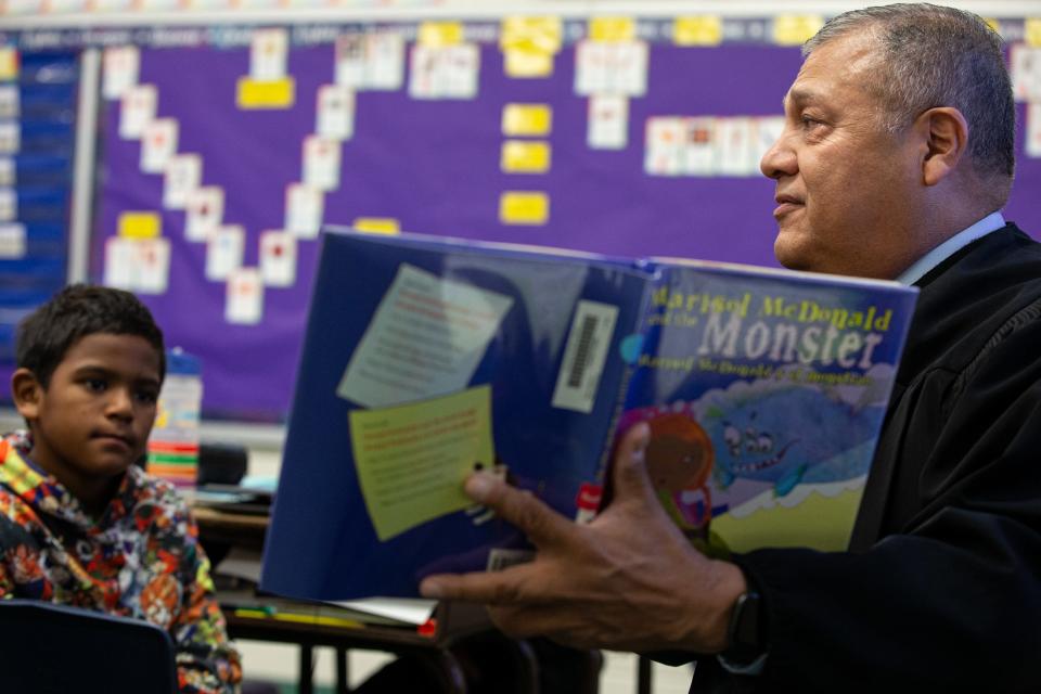 Third grade student Jordan Williams, 8, listens to Judge Joe Benavides read "Marisol McDonald and the Monster" for Hispanic Heritage Month at Blanche Moore Elementary School on Thursday, Sept. 28, 2023, in Corpus Christi, Texas.