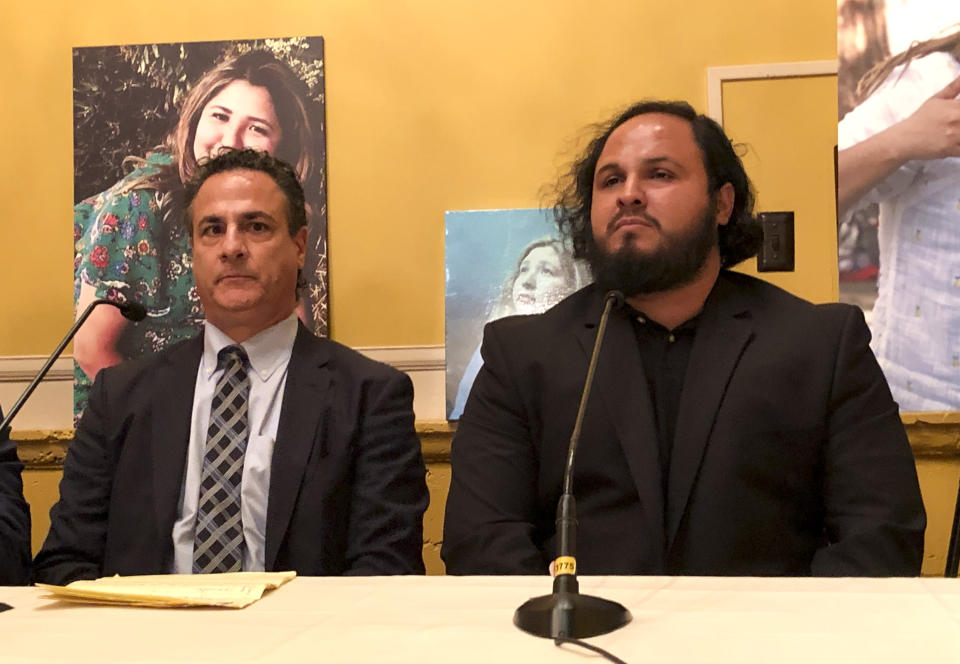 CORRECTS ALBERT CORADO JR. TO BROTHER OF MELY INSTEAD OF SON - Attorney, Ron Rosengarten, left, and Albert Corado Jr., brother of Mely Corado, who was accidentally killed by police when they tried to stop a gunman from entering a Los Angeles grocery store sit during a news conference Tuesday, Sept. 4, 2018, in Los Angeles. The family of a bystander accidentally killed by police when they tried to stop a gunman from entering a Los Angeles grocery store is blasting newly released video, saying it's crafted to paint officers in the best light. (AP Photo/Amanda Lee Myers)