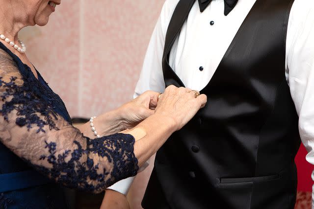 <p>Getty</p> stock photo of the mother of the groom and groom on their wedding day