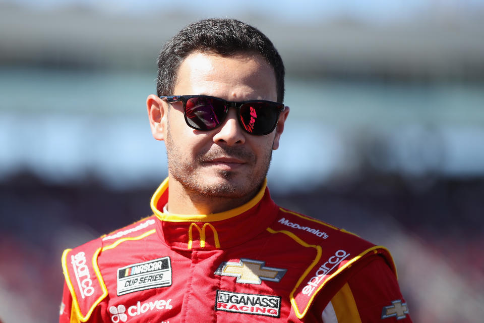 Kyle Larson wearing sunglasses and looking ahead.