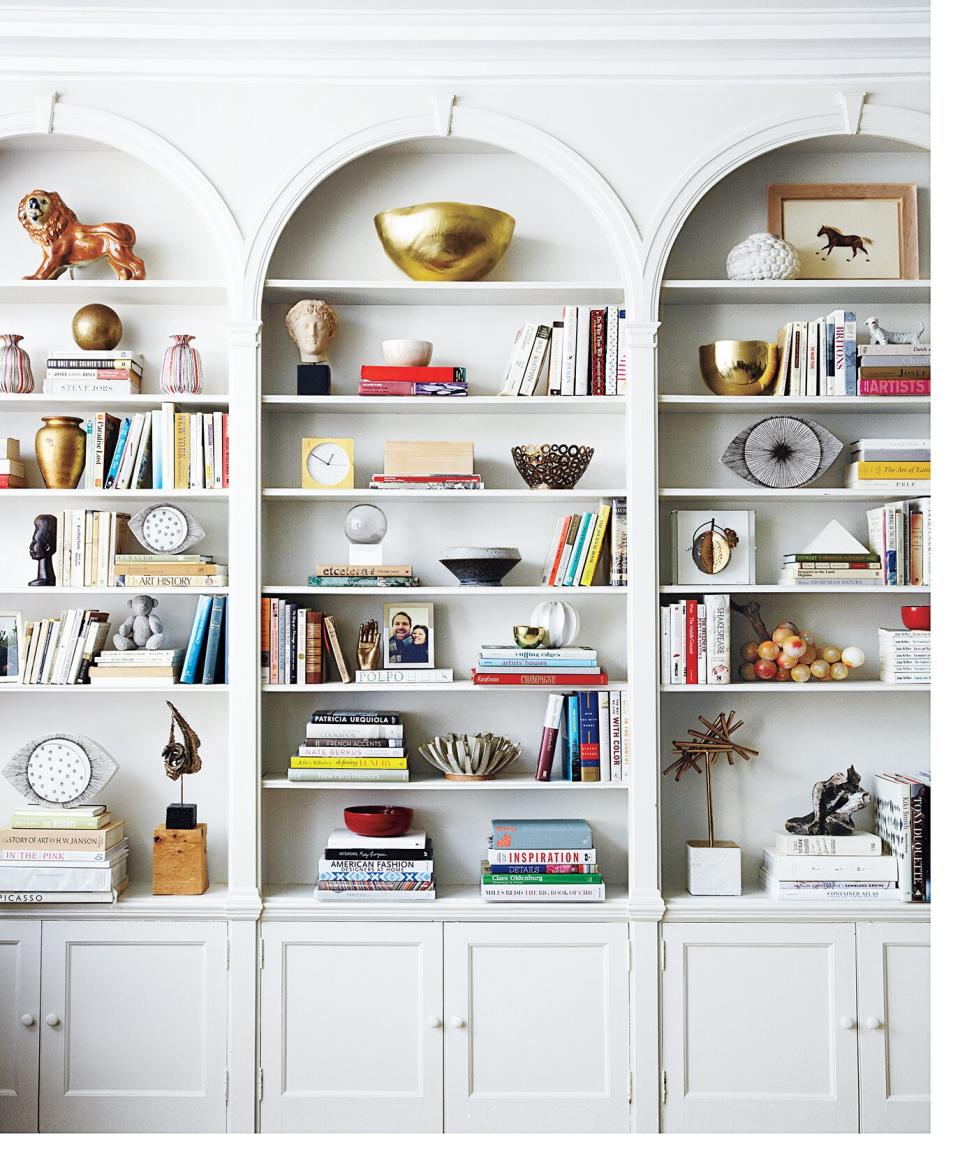 White bookcase with books and assorted objects on the shelves