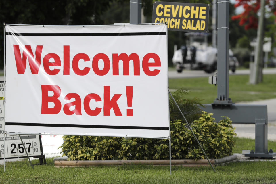 A sign welcomes visitors in Key Largo, in the Florida Keys, during the new coronavirus pandemic, Monday, June 1, 2020. The Florida Keys reopened for visitors Monday after the tourist-dependent island chain was closed for more than two months to prevent the spread of the coronavirus. (AP Photo/Lynne Sladky)