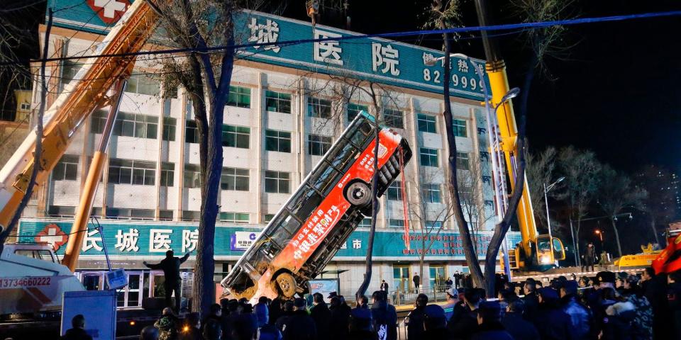 Bus being lifted out of the ground China sinkhole 