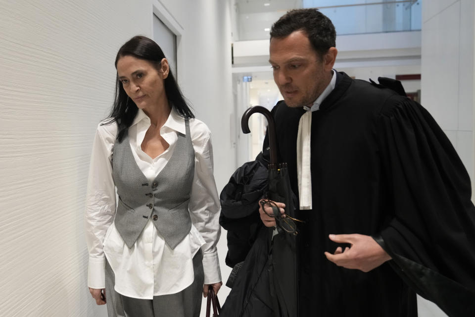 British actor Charlotte Lewis arrives with her lawyer Benjamin Chouai before the verdict against filmmaker Roman Polanski Tuesday, May 14, 2024 in Paris. Roman Polanski was acquitted of defaming the actor whom he described as a liar after she accused the director of sexual assault. (AP Photo/Thibault Camus)