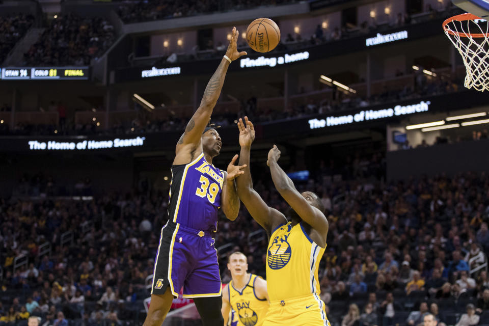 Los Angeles Lakers center Dwight Howard (39) shoots as Golden State Warriors forward Eric Paschall (7) defends in the first half of an NBA basketball game in San Francisco Saturday, Feb. 8, 2020. (AP Photo/John Hefti)